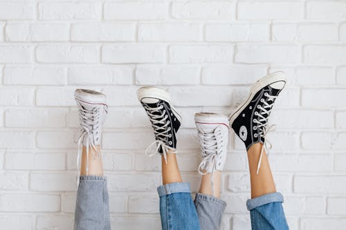 Free Feet on the Wall Wearing Sneakers Stock Photo