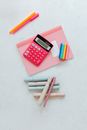 Pink Calculator Beside Brown Sticks