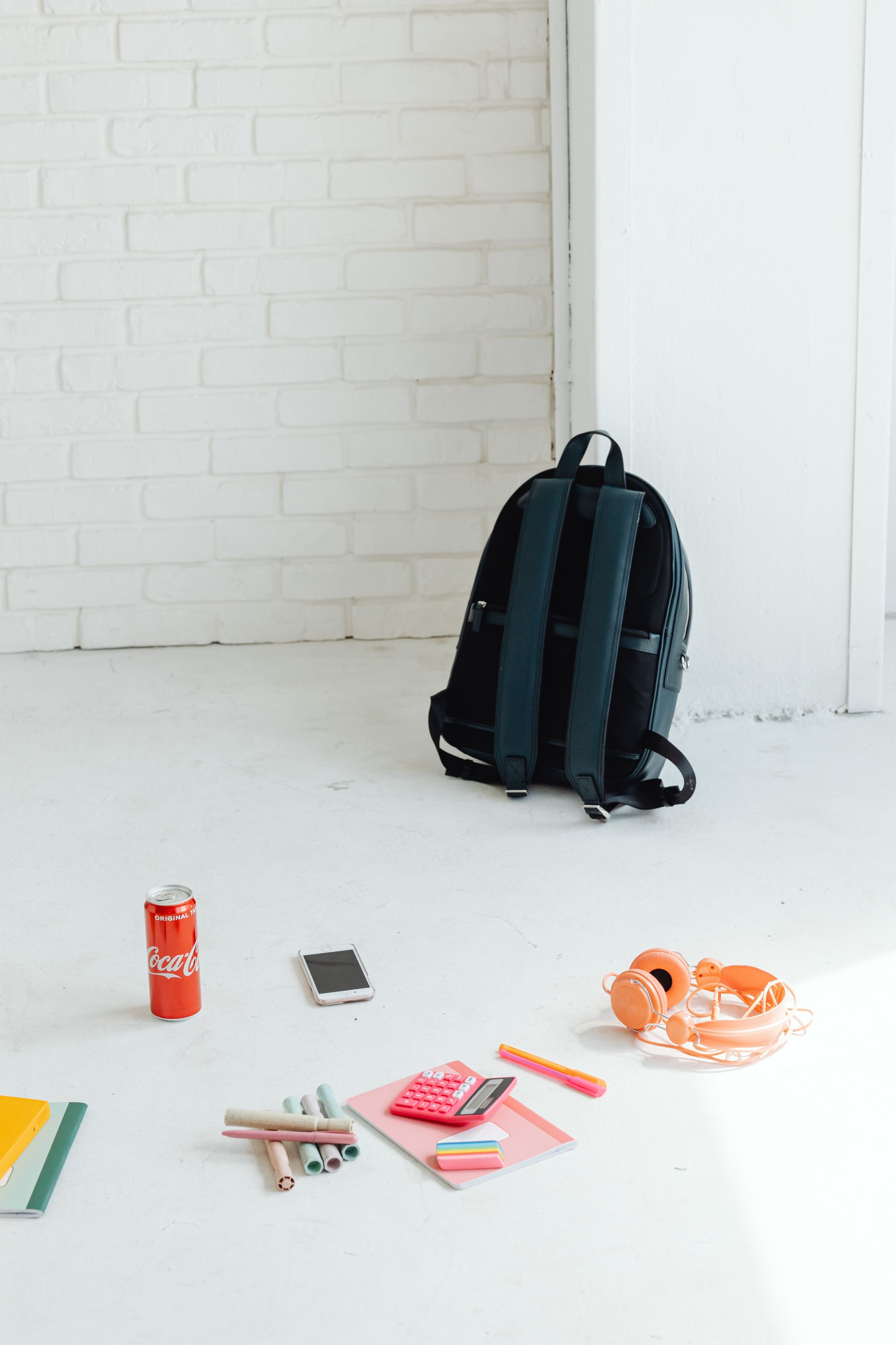 Top-down school backpack layout with laptop, notebook, and everyday essentials
