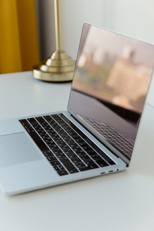 Free Laptop on White Desk Stock Photo