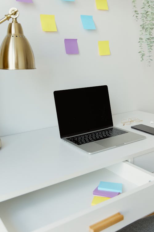 Free A Macbook Pro Laptop on White Desk Stock Photo