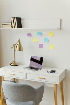 A minimalist home office featuring elegant furniture and colorful decor items.