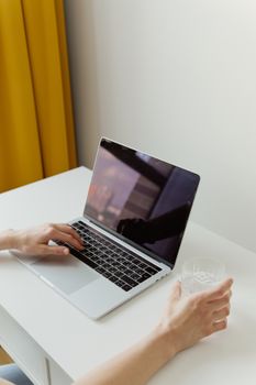Simple minimalist workspace with a laptop and a person working, ideal for office or remote work concepts.