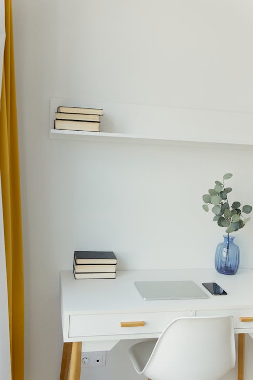 Free White Table Under a White Wall Shelf Stock Photo