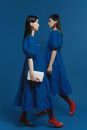 Women Wearing Blue Dresses Walking