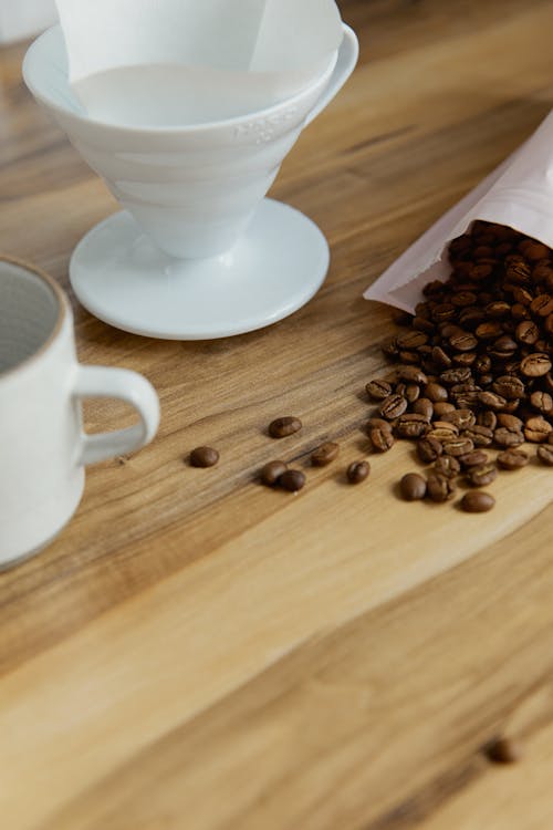 Free Coffee Beans Spilled on Kitchen Counter Stock Photo