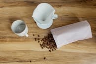 Coffee Beans Spill over the Wooden Table