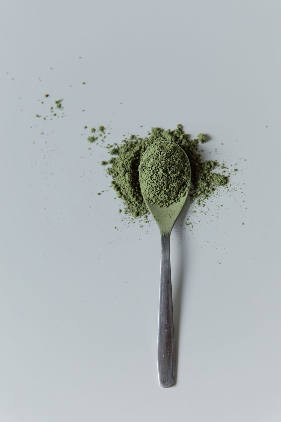 Jade matcha powder on a spoon