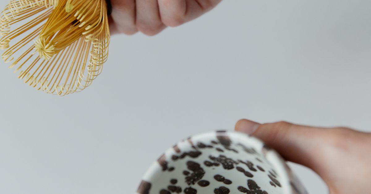 Matcha being whisked in a ceramic bowl by hand