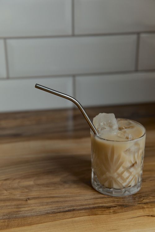 Free Refreshing iced coffee with a metal straw in a pattern glass, perfect for a summer day. Stock Photo