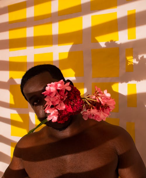 A Man Biting a Bunch of Flowers