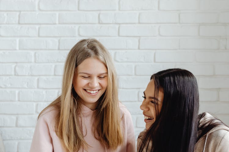 Happy Women In Hoodie Jacket Having A Conversation