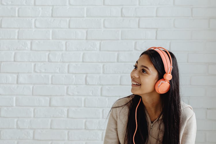 Smiling Female Teenager Listening To Music