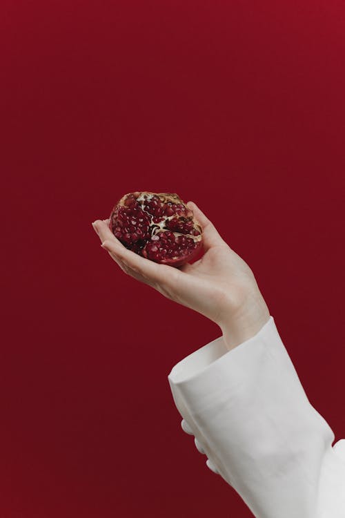 Person Holding Pomegranate