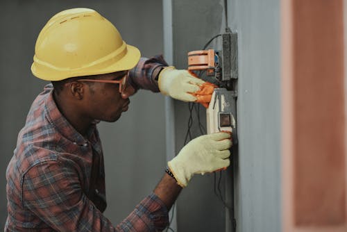 Free An Electrician Repairing a Fuse Box Stock Photo