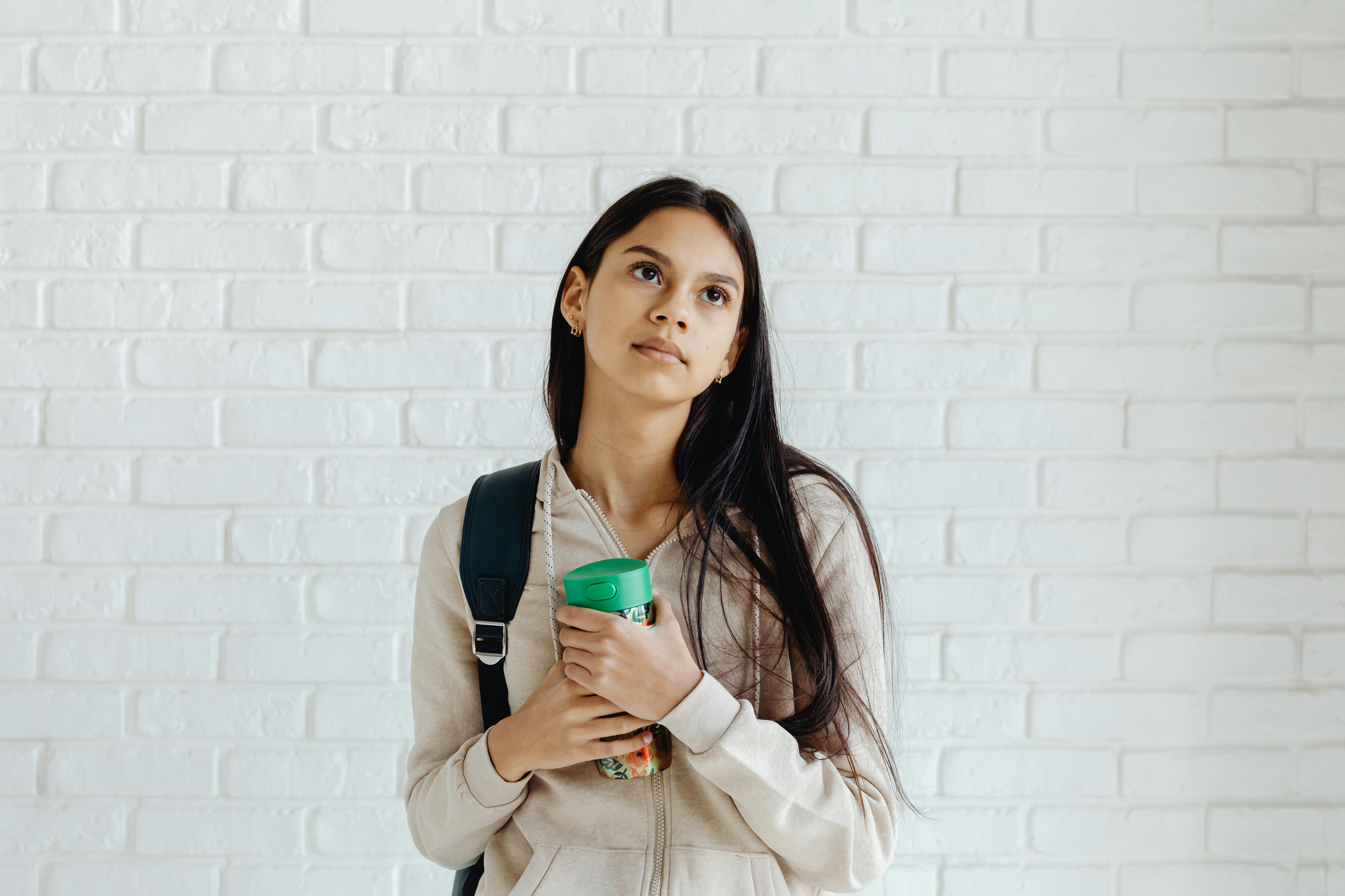 Modern thermostat mounted on a wall in a home showing temperature settings