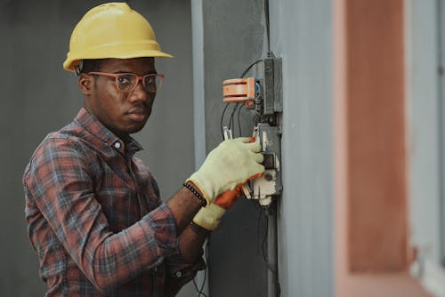 Free An Electrician Repairing a Fuse Box Stock Photo