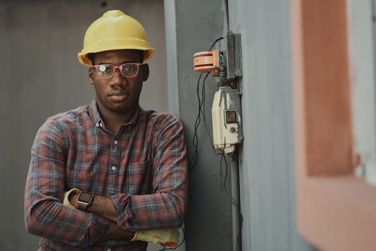 An Electrician Leaning Near The Fuse Box