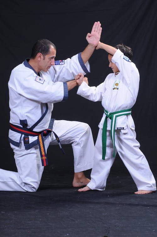 Free Boy and Man Practicing Tang Soo Do in White Kimonos Stock Photo