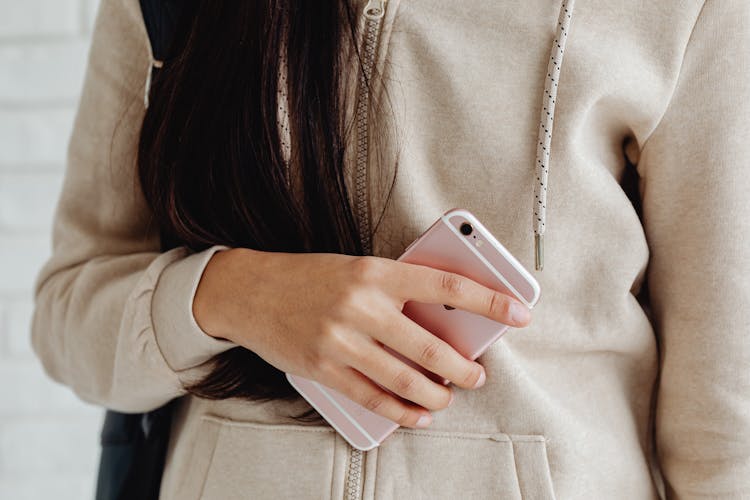 Pink Mobile Phone In Girl's Hand