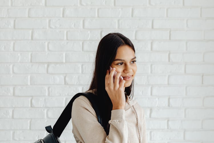 Girl In Beige Hoodie Talking On The Phone