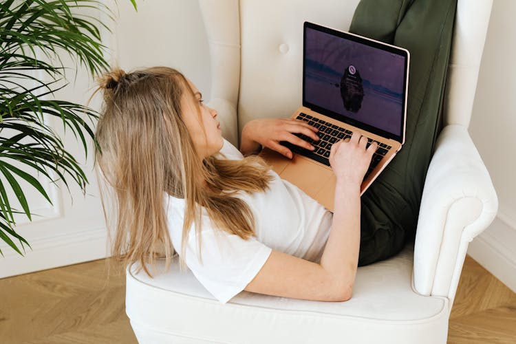 Female Teenager Using A Laptop