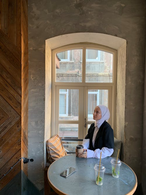 A Woman Sitting by the Window 