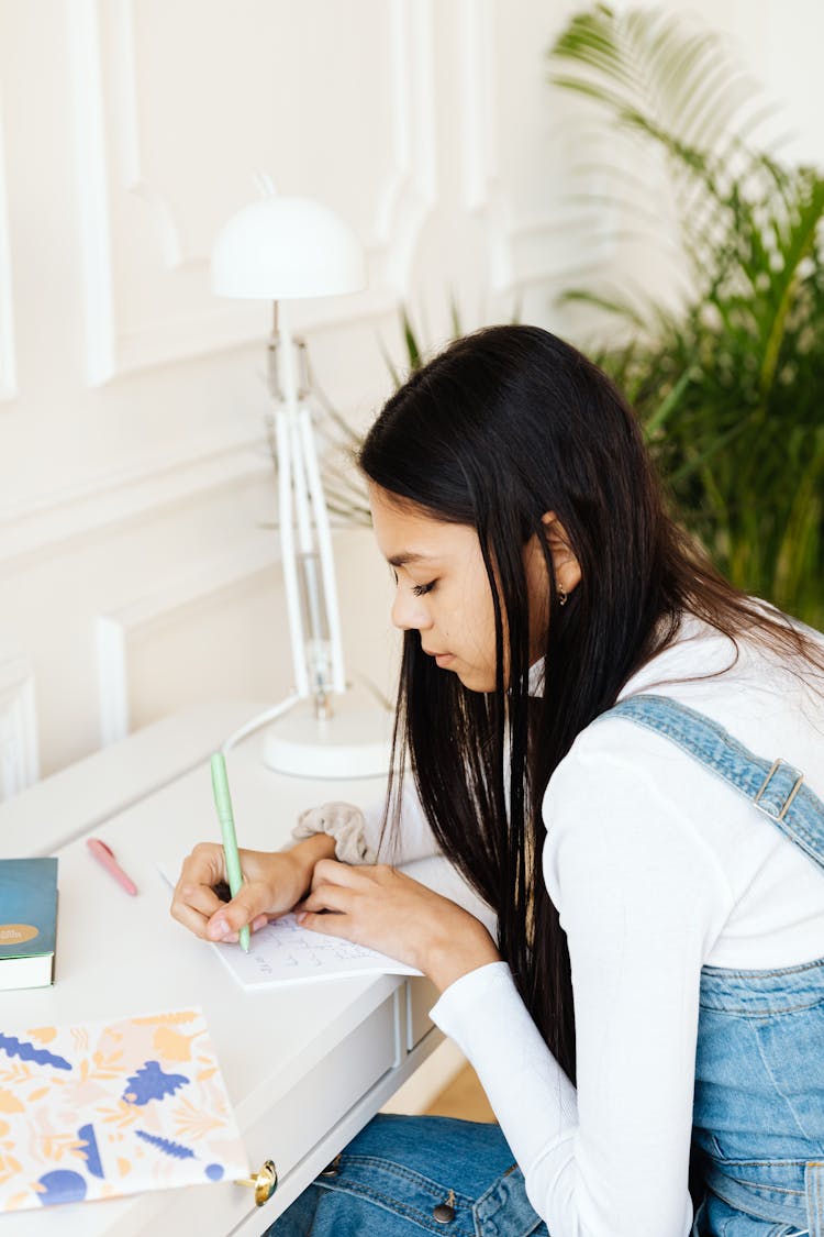 Brunette Woman Writing On Card