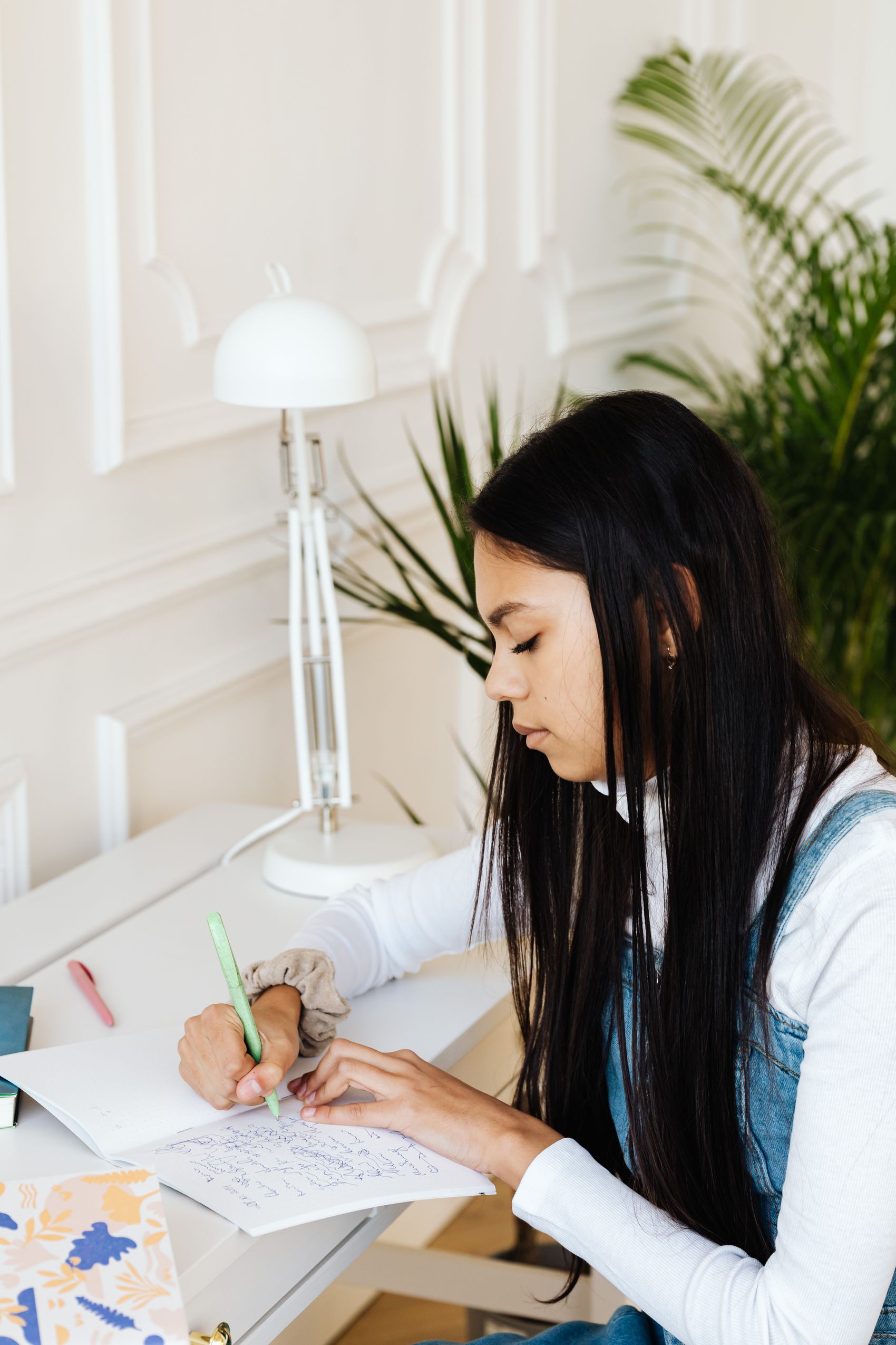 Girl concentrating on her maths homework at a desk