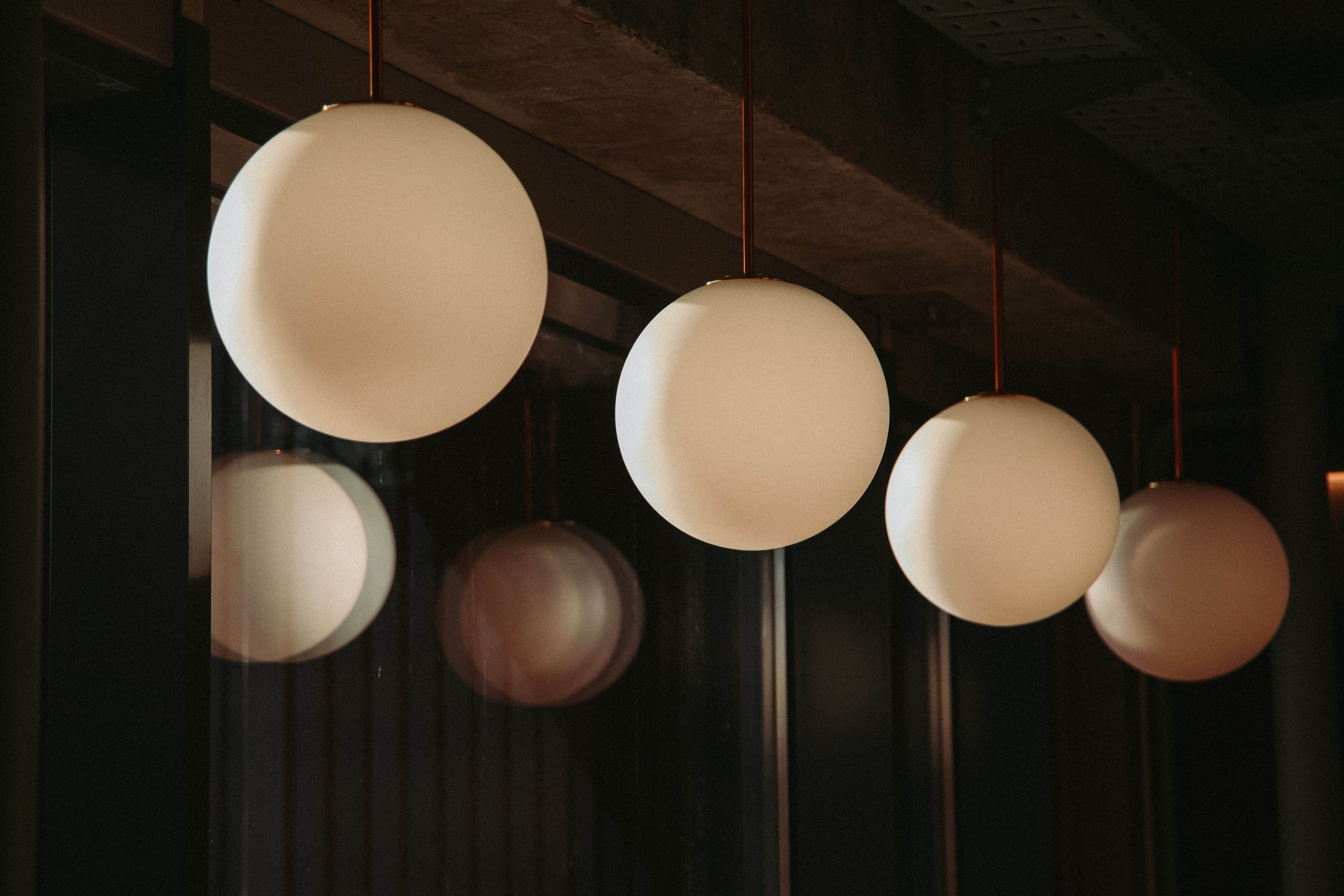 warm lit cafe dining room with leather banquette seating and brass pendant lamps