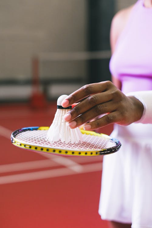 Woman Holding a Badminton Racket and a Shuttlecock 