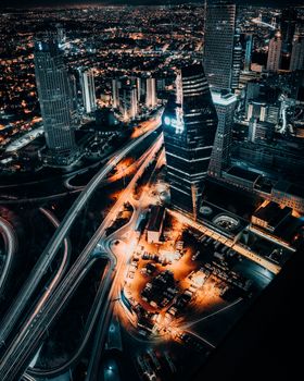 Stunning aerial shot showcasing İstanbul's illuminated cityscape and skyscrapers at night.