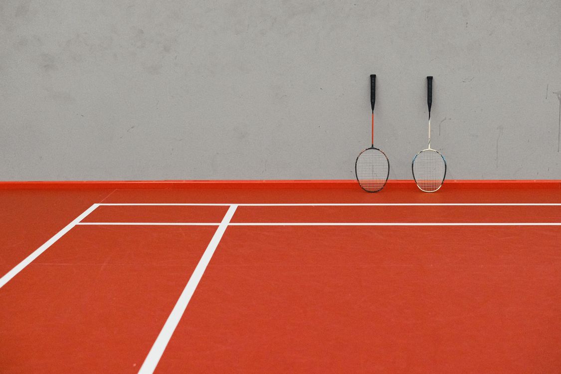 Badminton Racquets on Court · Free Stock Photo