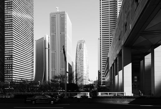 Dramatic black and white view of Tokyo's modern skyscrapers in daylight.