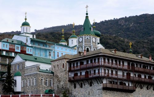 Free Explore the intricate architectural details of a historic Orthodox monastery set against a picturesque mountainous backdrop in Greece. Stock Photo