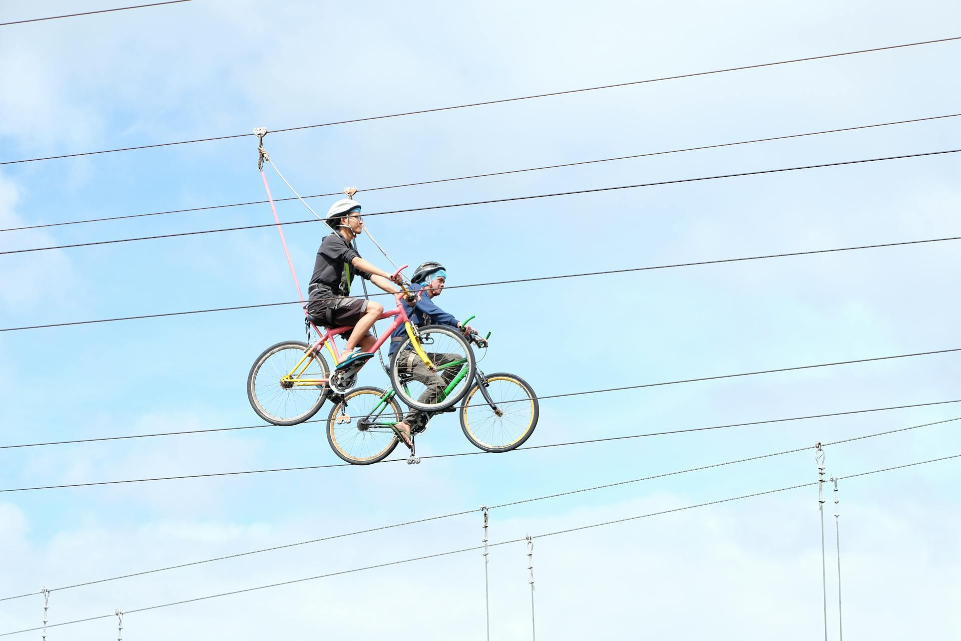 Exciting adventure cycling on a zip line in Talisay City under a clear sky.