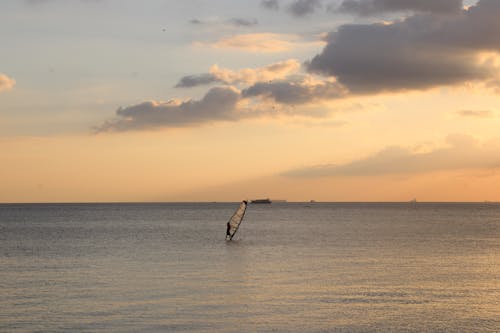 A Person Windsurfing On The Sea