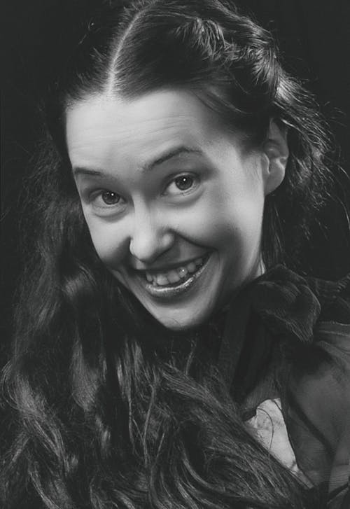 Grayscale Photo of a Woman with a Happy Facial Expression