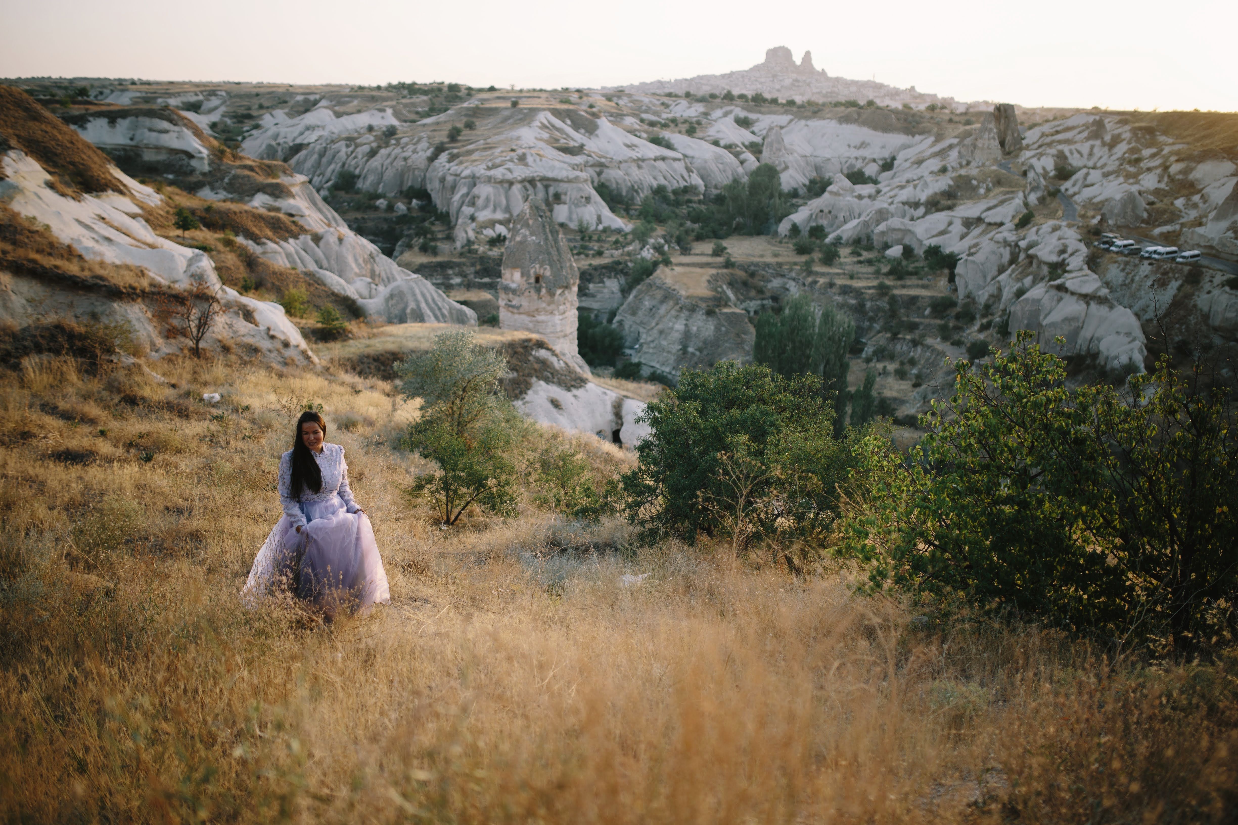 [ColoSach]-asian-woman-in-a-purple-dress-walking-through-the-unique-landscapes-of-cappadocia,-turkey.