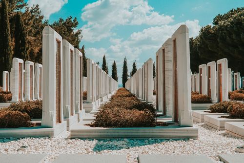 Free Rows of marble tombstones under a bright sky at Çanakkale Cemetery, capturing a peaceful summer atmosphere. Stock Photo