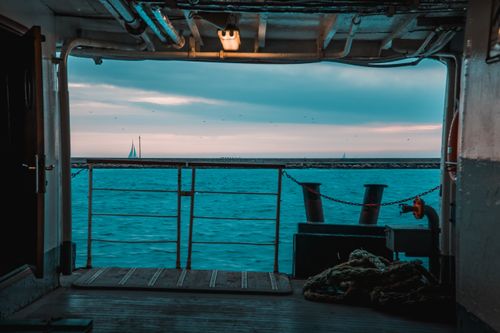 Free A serene view of the sea from a ferry deck in İstanbul with sailboats on the horizon. Stock Photo