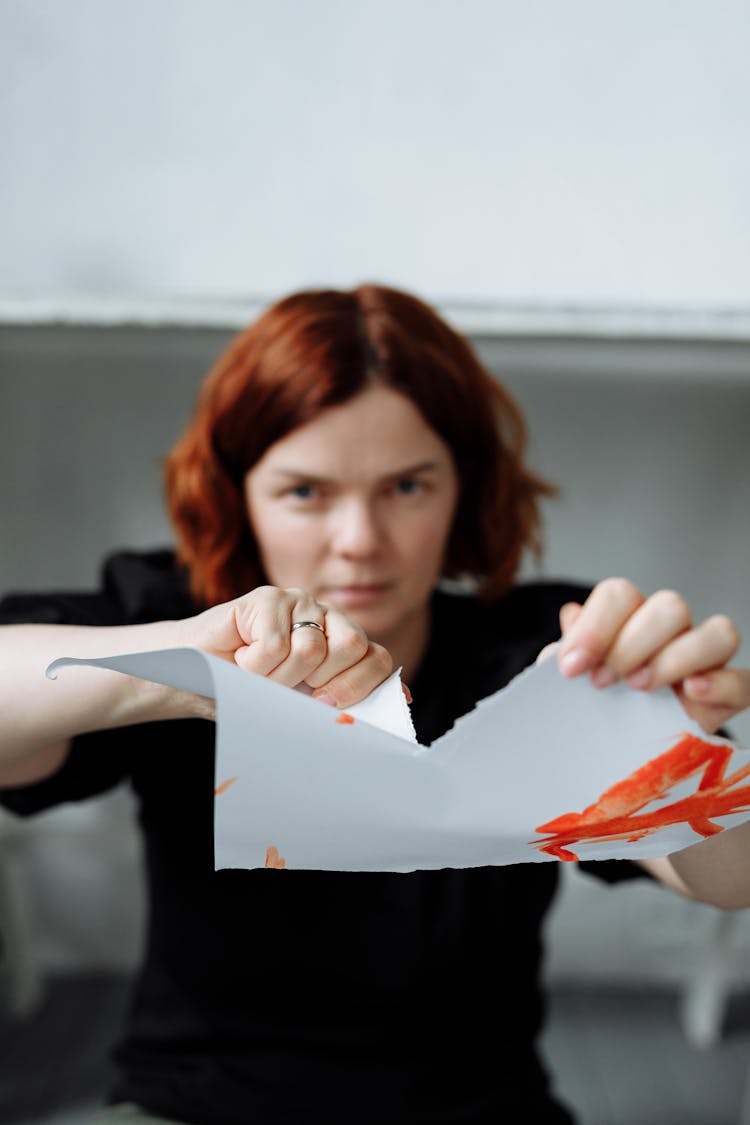 A Woman Tearing A Paper