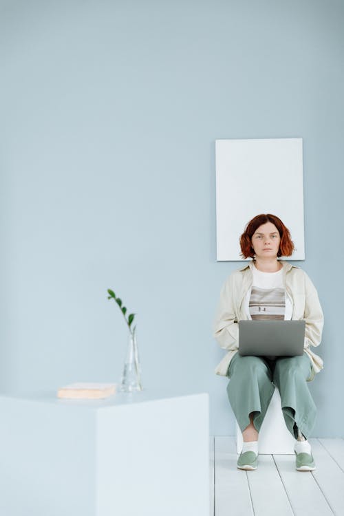 Woman with a Prosthetic Leg Working on a Laptop 