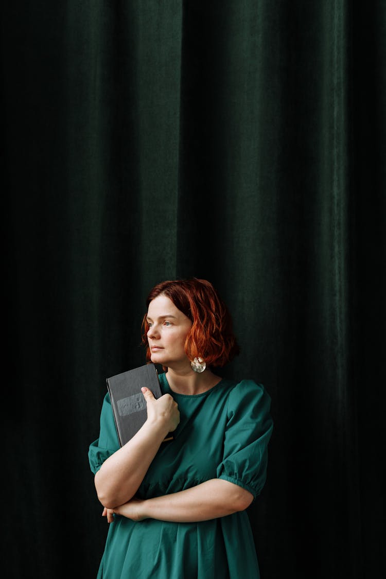 A Woman Holding A Book