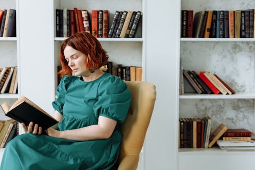 Free A Woman Serious Reading the Book Stock Photo