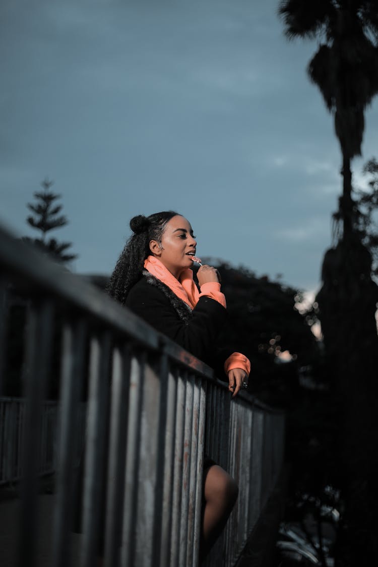 A Woman Eating Lollipop