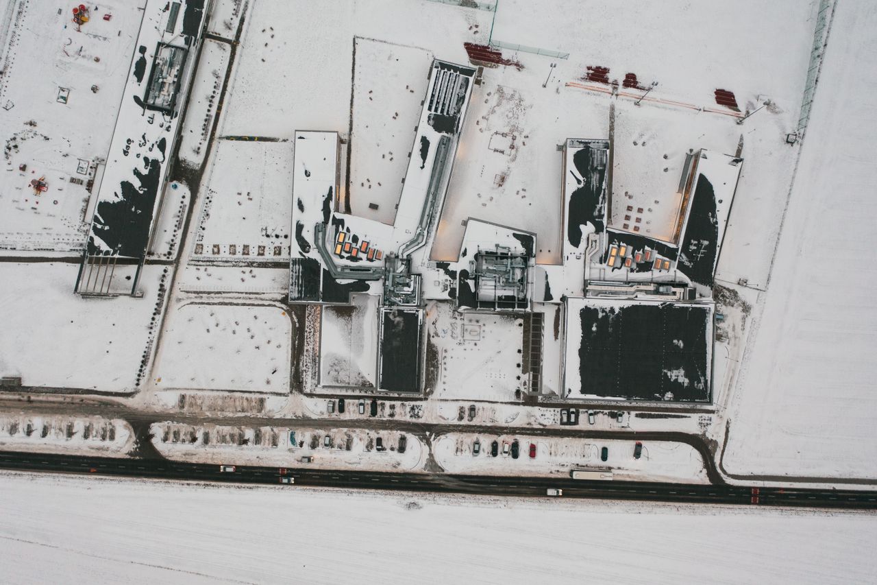 a top down aerial view of a snow covered industrial area in pozna pola