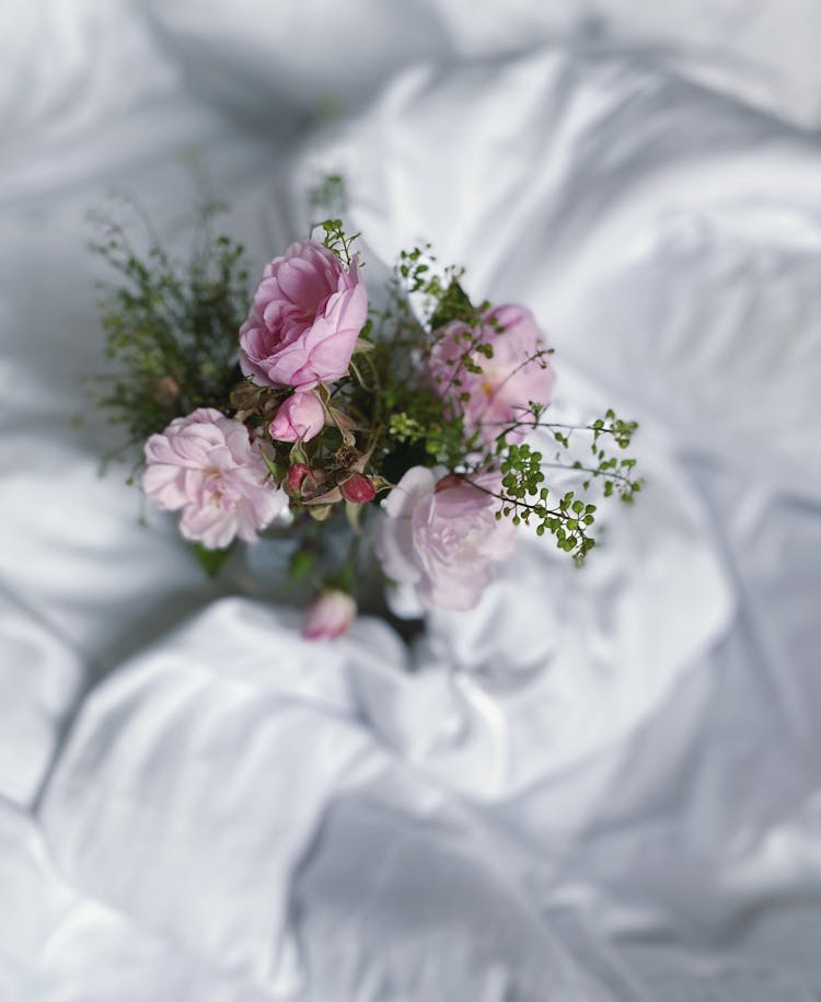 Pink And White Roses On White Sheets