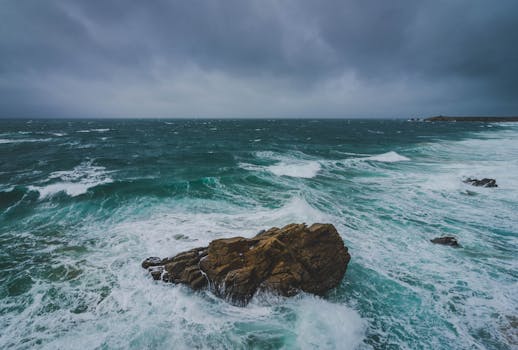 Powerful waves crash against rocks on the stormy coast of Quiberon, France.