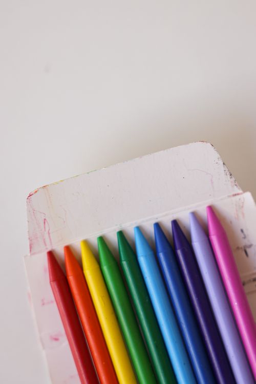 Free Colorful set of crayons in a box, perfect for art and crafts, on a white background. Stock Photo